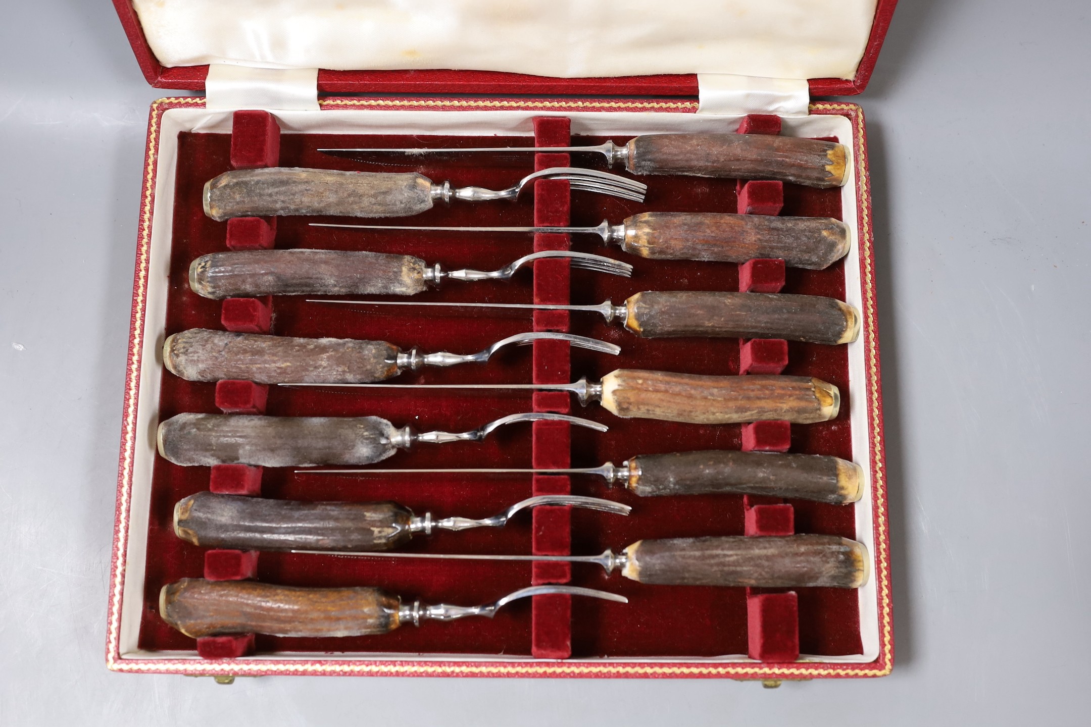 Four cased sets of flatware, including silver 'berry spoons', tea knives, teaspoons and horn handles knives and forks.